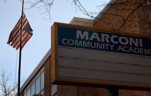 An American flag flies outside of Marconi Community Academy, one of more than 50 elementary schools scheduled to be closed in Chicago.